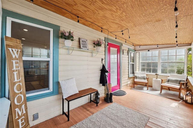 sunroom / solarium featuring wood ceiling