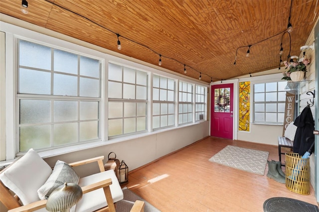 sunroom with lofted ceiling and wood ceiling