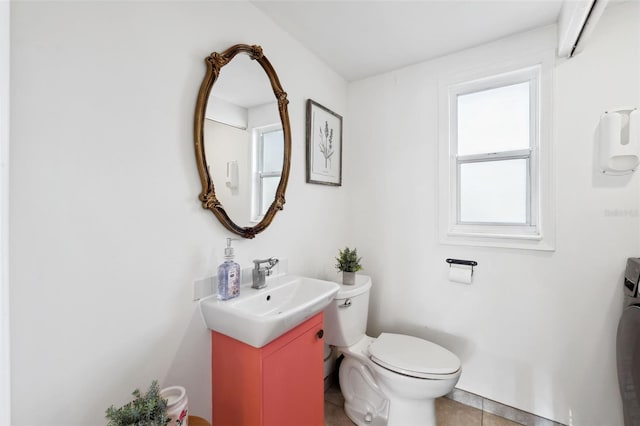 bathroom with tile patterned flooring, vanity, and toilet