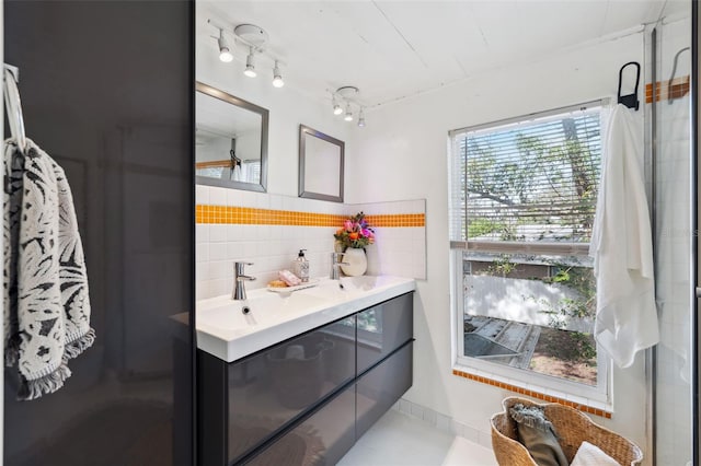 bathroom featuring vanity and backsplash