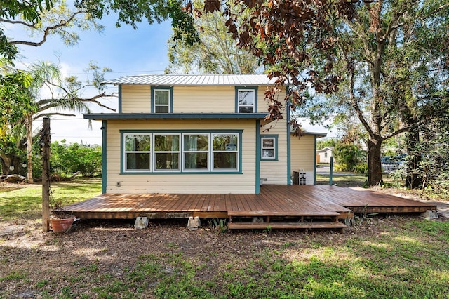 back of house featuring cooling unit and a wooden deck