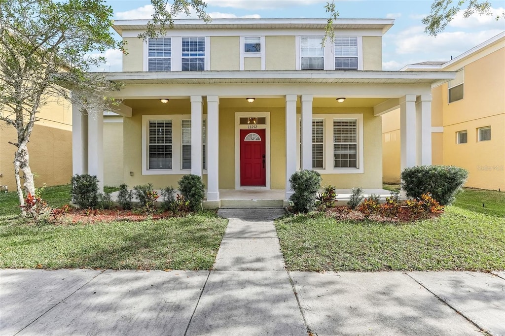 property entrance with a porch and a lawn