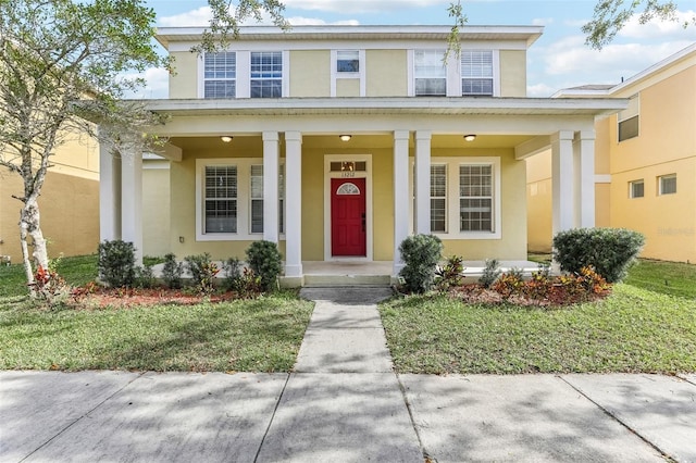 property entrance with a porch and a lawn