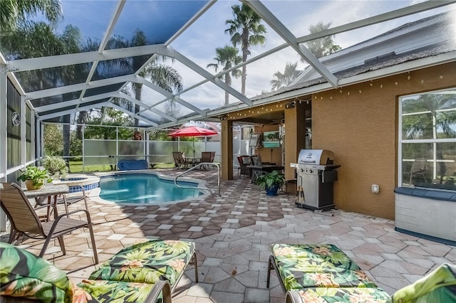 view of swimming pool with a hot tub, glass enclosure, area for grilling, and a patio area