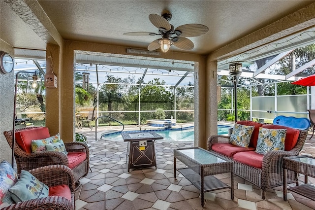 sunroom with a pool and ceiling fan