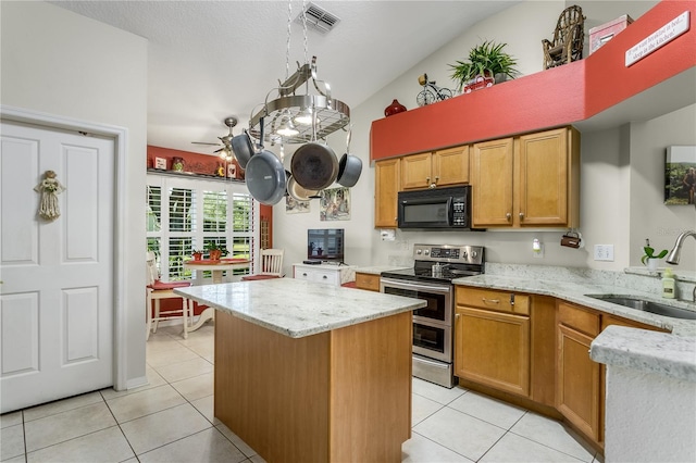 kitchen featuring stainless steel electric range oven, sink, light tile patterned floors, and vaulted ceiling