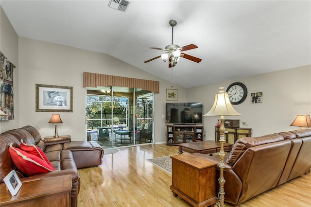 living room featuring light hardwood / wood-style floors, vaulted ceiling, and ceiling fan