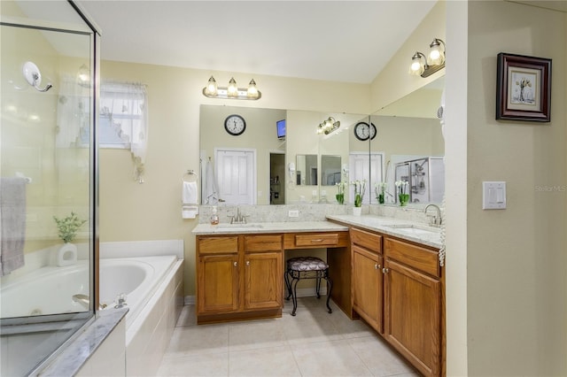 bathroom featuring tile patterned flooring, vanity, and shower with separate bathtub