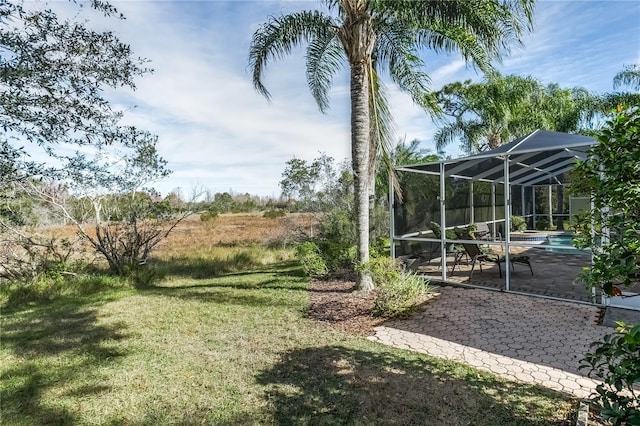 view of yard featuring a patio area and a lanai