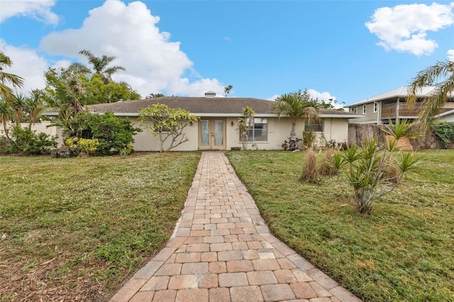 single story home featuring french doors and a front yard