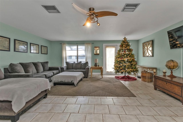 living room featuring ceiling fan and light tile patterned flooring