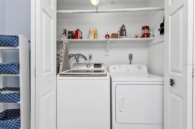 laundry room featuring washing machine and clothes dryer