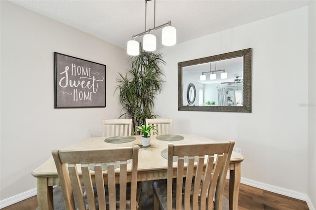 dining area featuring dark hardwood / wood-style floors and a textured ceiling