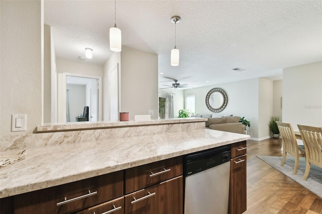 kitchen featuring pendant lighting, dishwasher, hardwood / wood-style floors, a textured ceiling, and dark brown cabinetry