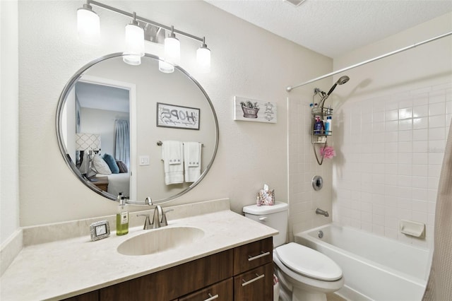 full bathroom featuring vanity, a textured ceiling, toilet, and shower / tub combo with curtain