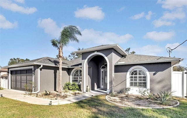 view of front of home with a front yard and a garage