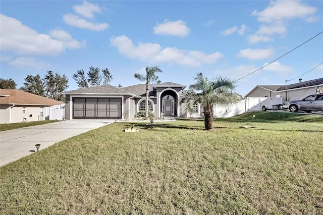 ranch-style home with a garage and a front lawn