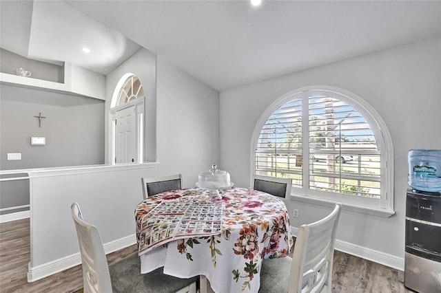 dining space with wood-type flooring