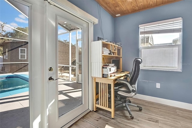 office featuring a healthy amount of sunlight, wood-type flooring, and wooden ceiling