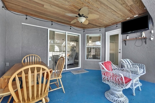 sunroom / solarium with ceiling fan and wood ceiling