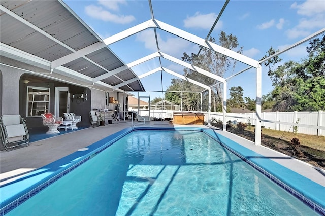 view of pool with a lanai, a patio, and a hot tub