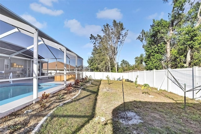 view of yard with a lanai and a fenced in pool