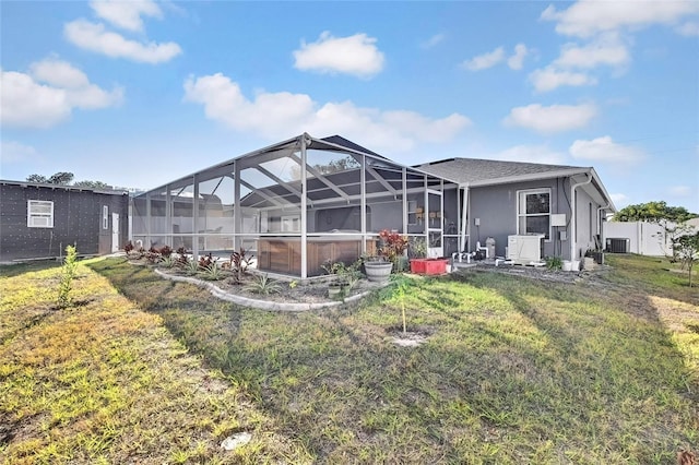 back of property featuring ac unit, a yard, and a lanai