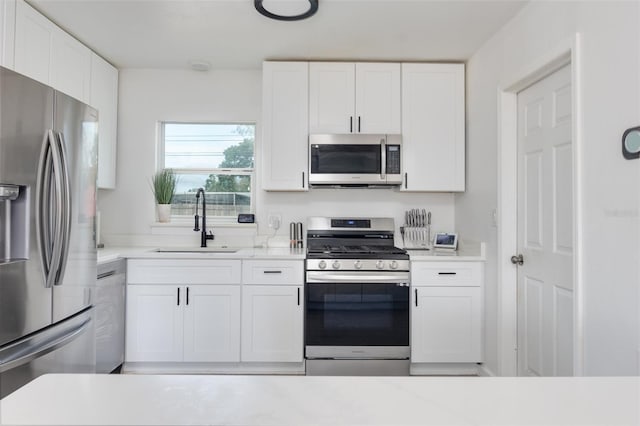 kitchen with white cabinetry, sink, and appliances with stainless steel finishes