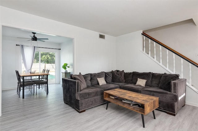 living room with ceiling fan and light wood-type flooring