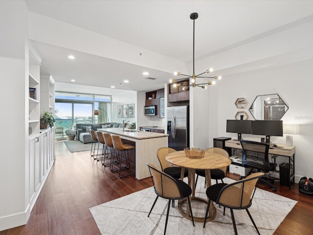 dining area featuring sink, a chandelier, built in features, and dark hardwood / wood-style floors