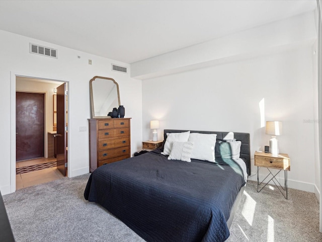 carpeted bedroom with connected bathroom