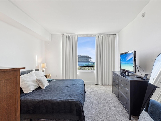 bedroom featuring light carpet