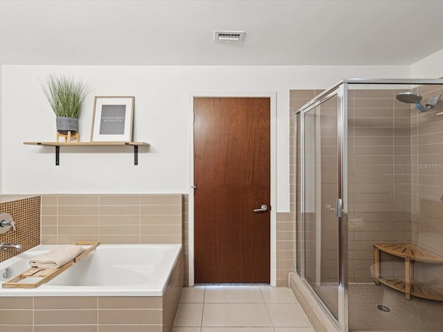 bathroom with shower with separate bathtub and tile patterned floors