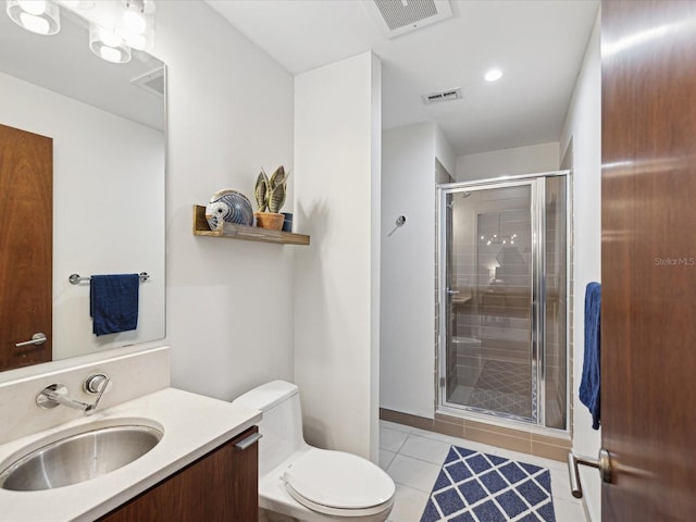 bathroom with toilet, an enclosed shower, tile patterned floors, and vanity