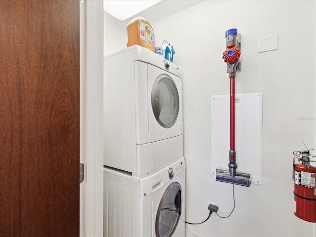 washroom featuring stacked washer / dryer