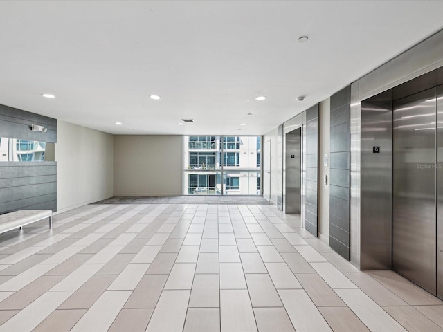 interior space with elevator and expansive windows