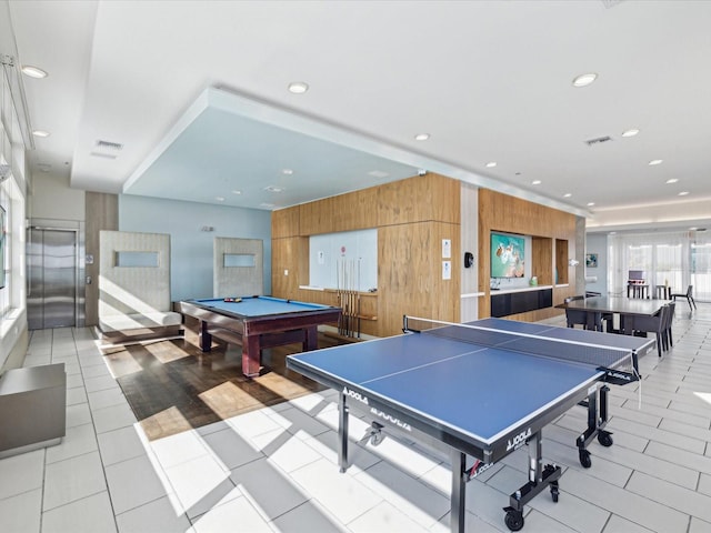 playroom with wooden walls, billiards, light tile patterned floors, and elevator