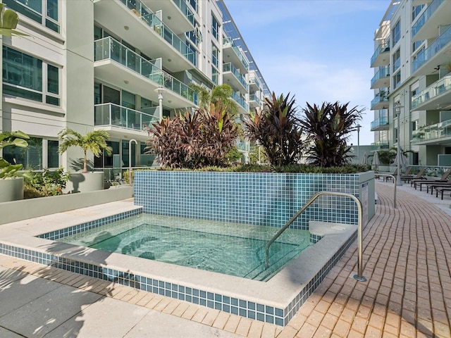 view of swimming pool with a community hot tub