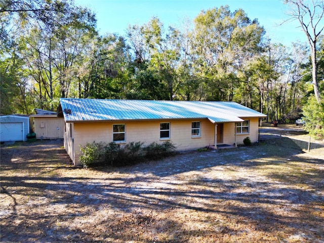 single story home with a storage unit