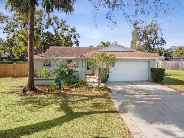 ranch-style house with a garage and a front lawn