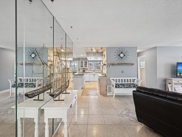 tiled living room featuring a textured ceiling