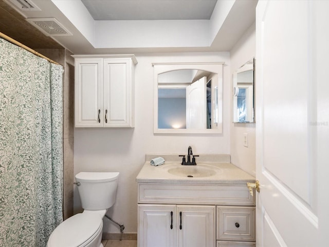 bathroom featuring toilet and vanity