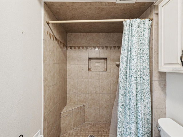 bathroom featuring toilet and a shower with shower curtain