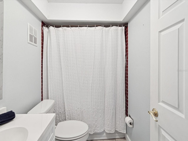 bathroom featuring toilet, vanity, and walk in shower