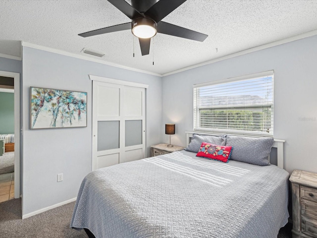 carpeted bedroom featuring ceiling fan, crown molding, and a textured ceiling