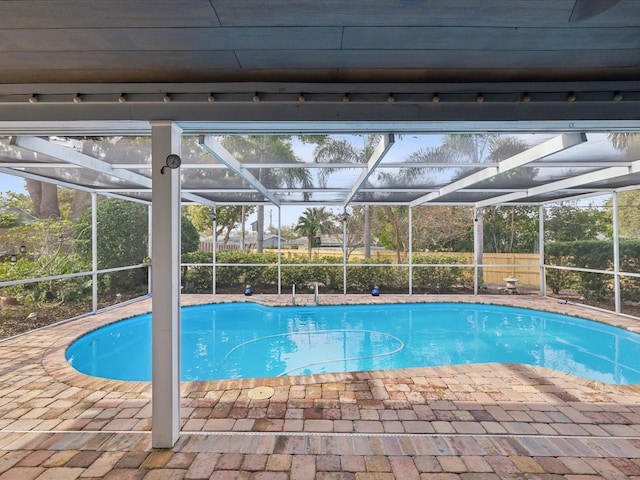 view of pool featuring a patio and glass enclosure