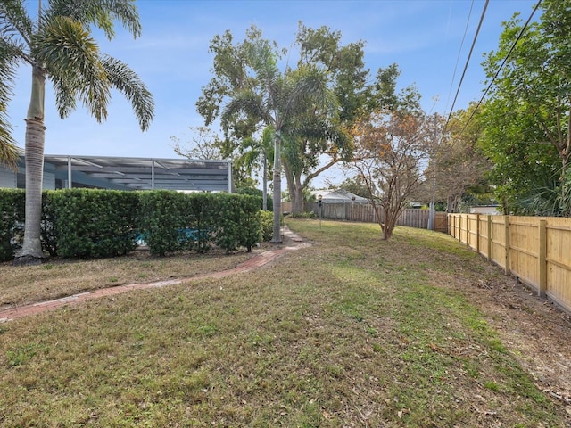 view of yard featuring glass enclosure