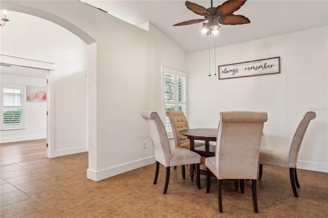 dining area featuring lofted ceiling, ceiling fan, and a healthy amount of sunlight