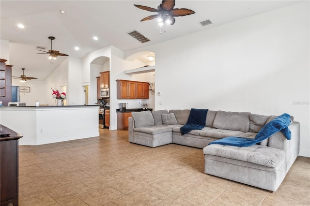 living room with ceiling fan and high vaulted ceiling