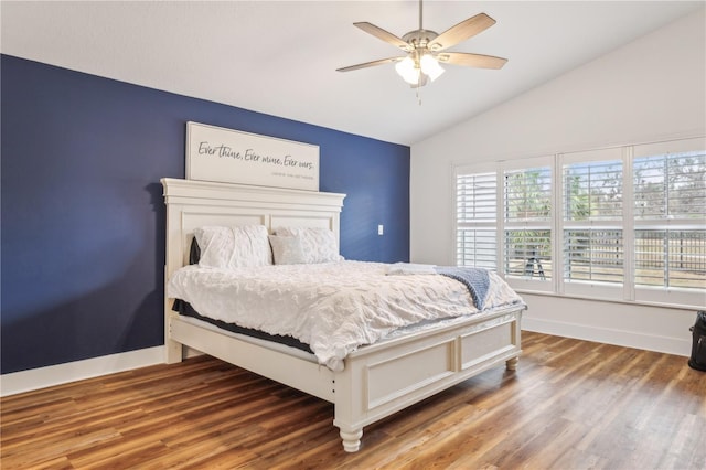 bedroom with hardwood / wood-style floors, vaulted ceiling, and ceiling fan